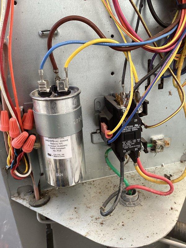 Performed scheduled maintenance on heat system with CCH contract valid until 8/9/2026. Inspected electrical components including capacitor, contactor and wiring connections. Noted standing water near equipment requiring attention and documented condition of filter system with pink tag indicator for future reference.