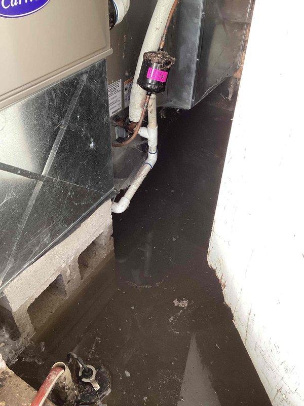 Performed scheduled maintenance on heat system with CCH contract valid until 8/9/2026. Inspected electrical components including capacitor, contactor and wiring connections. Noted standing water near equipment requiring attention and documented condition of filter system with pink tag indicator for future reference.