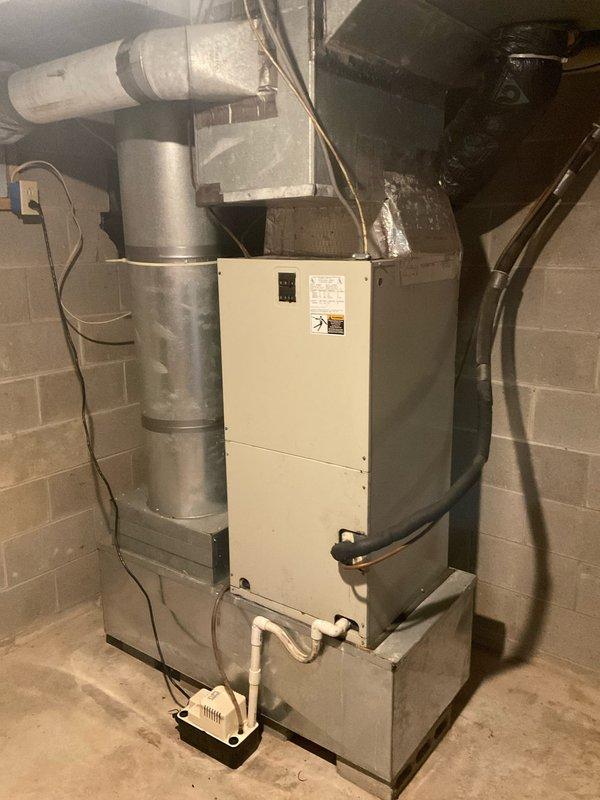 Completed full system evaluation of 2006 R22 heat pump with 2000 electric furnace that is currently out of refrigerant. Discussed replacement options including conversion to propane furnace versus new heat pump system. Documented existing installation in utility room with connected ductwork, condensate system, and adjacent water treatment equipment. Customer requests installation within one week timeframe.
