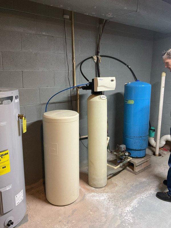 Completed full system evaluation of 2006 R22 heat pump with 2000 electric furnace that is currently out of refrigerant. Discussed replacement options including conversion to propane furnace versus new heat pump system. Documented existing installation in utility room with connected ductwork, condensate system, and adjacent water treatment equipment. Customer requests installation within one week timeframe.