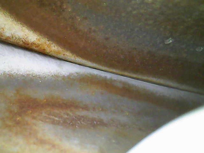 Performed diagnostic inspection on 10+ year old heating system that revealed significant rust and corrosion on heat exchanger components. Visual examination confirmed advanced oxidation at critical junction points, indicating moisture exposure and long-term deterioration. Recommended full system replacement due to safety concerns and compromised operational integrity.