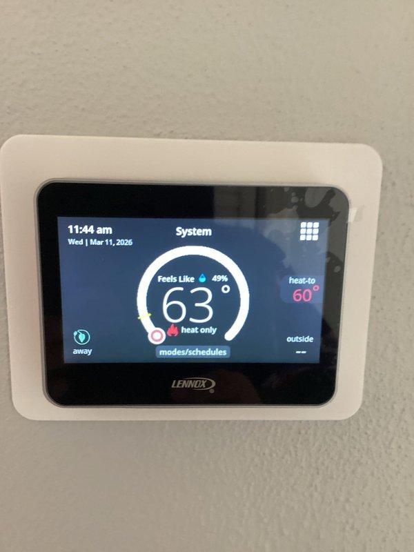 Responded to warranty service call for recently installed Lennox heat pump system that customer reported would not turn on. Inspected outdoor condenser unit and Lennox digital thermostat, which was properly displaying temperature readings and set to "heat only" mode with a heat-to temperature of 60°. Resolved operational issue and verified system functionality before completing the service.