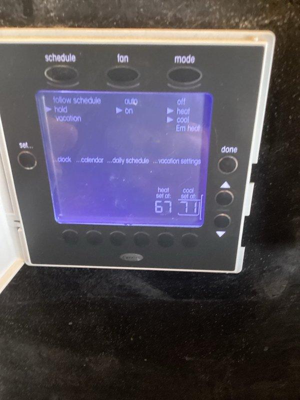 Responded to service call for air conditioner making unusual noises. Inspected Carrier HVAC system with programmable thermostat functioning at 71°F. Verified proper operation of all thermostat functions including schedule, fan settings, and mode selections. No operational issues detected with thermostat controls or display functionality.