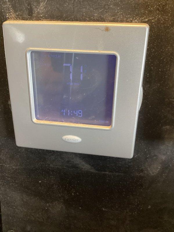 Responded to service call for air conditioner making unusual noises. Inspected Carrier HVAC system with programmable thermostat functioning at 71°F. Verified proper operation of all thermostat functions including schedule, fan settings, and mode selections. No operational issues detected with thermostat controls or display functionality.