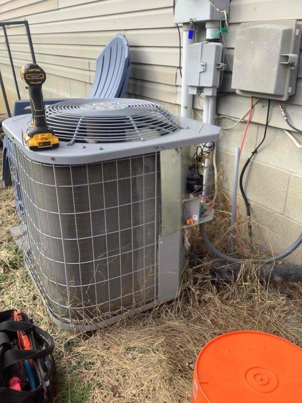 Performed diagnostic assessment on residential HVAC system following reported ongoing issues after major system rework. Inspected both furnace unit (with HEE logo) and outdoor AC condenser unit, utilizing pressure testing equipment to evaluate system performance and determine warranty eligibility.