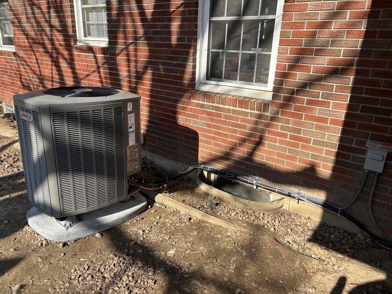 Completed installation of a new Lennox Heat Pump System at residential property. Installed outdoor condenser unit on concrete pad adjacent to brick exterior wall, with proper refrigerant line connections and secure mounting. System is functioning as designed with all components properly sized according to specifications (16X25X4).