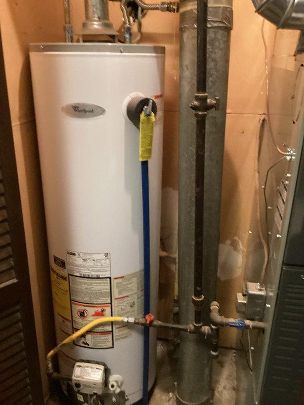 Diagnosed and resolved no water issue by replacing failed water heater. Installed new Whirlpool unit with proper connections to existing water supply lines and gas line, ensuring proper ventilation through existing galvanized ductwork. System tested and confirmed operational with all connections secure.