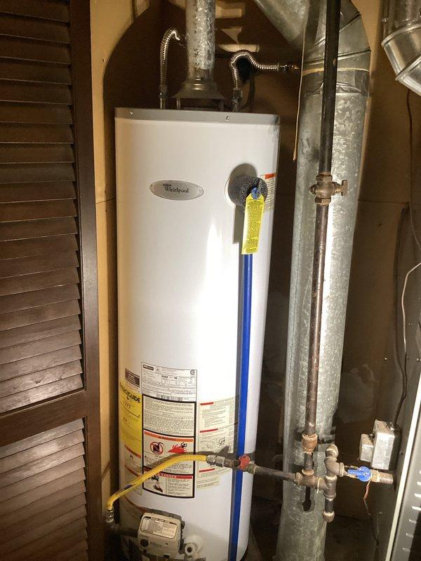 Diagnosed and resolved no water issue by replacing failed water heater. Installed new Whirlpool unit with proper connections to existing water supply lines and gas line, ensuring proper ventilation through existing galvanized ductwork. System tested and confirmed operational with all connections secure.