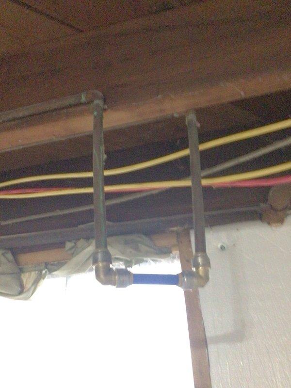 Completed prepaid plumbing inspection as requested. Examined copper/galvanized piping installation in ceiling area and inspected basement utility corner with black insulated pipe connected to brass fittings and red-handled valve. Documented areas where customer indicated potential replacements may be desired.