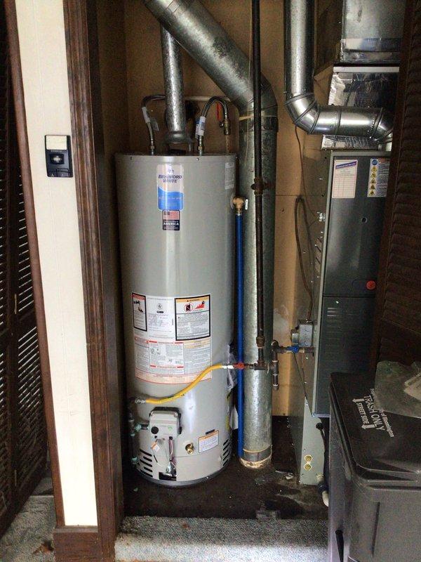 Successfully replaced a 50-gallon Bradford White natural gas water heater in the utility closet, including proper installation of all required ventilation components and connection of water lines with new flex hoses. Verified proper operation of the new unit and ensured all gas and water connections were secure with no leaks present.
