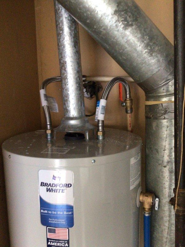 Successfully replaced a 50-gallon Bradford White natural gas water heater in the utility closet, including proper installation of all required ventilation components and connection of water lines with new flex hoses. Verified proper operation of the new unit and ensured all gas and water connections were secure with no leaks present.