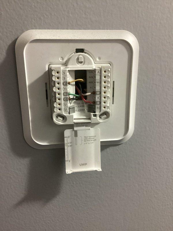 Performed after-hours tune-up on HVAC system to address customer's high utility bill concerns. Inspected Honeywell ProSeries thermostat wiring connections and verified proper terminal connections (R,G,Y,W). Confirmed system operation with thermostat showing 71°F temperature reading and proper fan auto function.