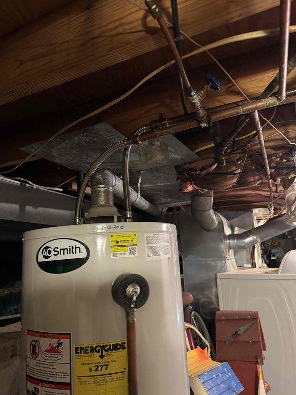 Performed routine maintenance inspection on residential HVAC system, including Carrier furnace unit mounted on concrete blocks and AO Smith water heater. Inspected all connections, PVC ventilation piping, condensate pump operation, and checked ductwork for proper installation and function.