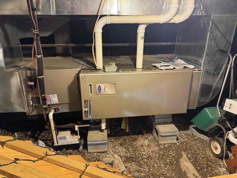 Performed routine maintenance inspection on residential HVAC system, including Carrier furnace unit mounted on concrete blocks and AO Smith water heater. Inspected all connections, PVC ventilation piping, condensate pump operation, and checked ductwork for proper installation and function.