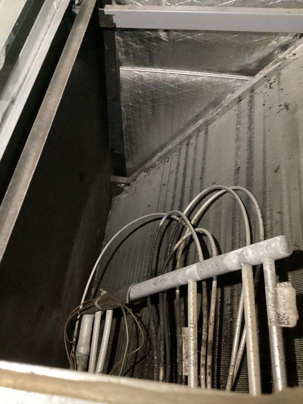 Performed monthly maintenance service on commercial cooling/heating unit. Observed significant dust accumulation on exterior components and housing. Noted frost buildup on refrigerant lines and cooling coils, indicating potential refrigerant flow issues that require further investigation.