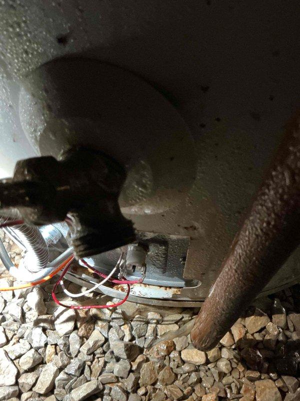 Performed diagnostic assessment on non-functioning water heater. Visual inspection revealed significant corrosion at connection points and aging components (installed approximately 2015-2020). Observed moisture accumulation and potential electrical issues with wiring connections. Estimate provided for replacement of the deteriorated unit.