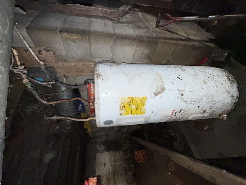 Completed the well pump installation and retrieved sump pumps as scheduled. Installed a new pressure tank with proper PVC connections to the existing water system. The complete installation is operational and properly fitted to the concrete utility area.