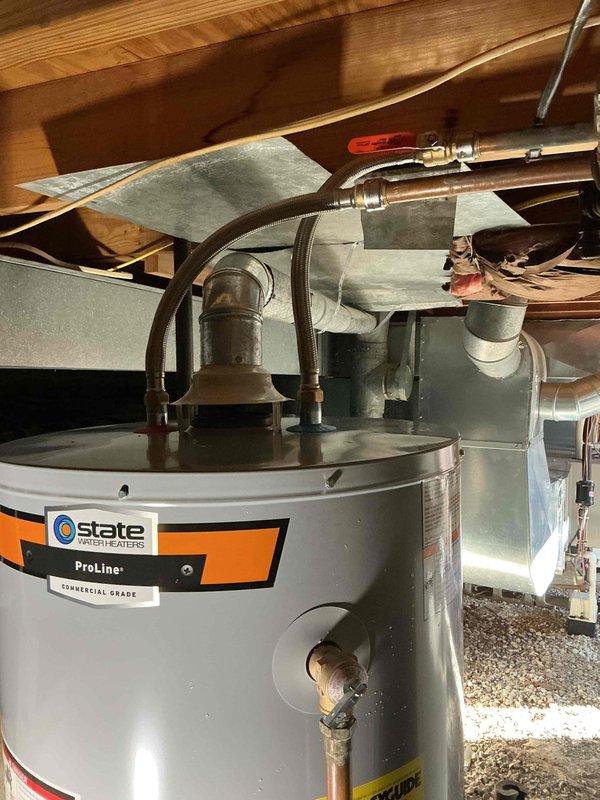 Successfully installed a new State ProLine Commercial Grade water heater in the utility area. Connected copper supply lines to the unit with proper fittings and installed flexible connections to accommodate thermal expansion. System was properly connected to existing gas line and verified to be functioning correctly.