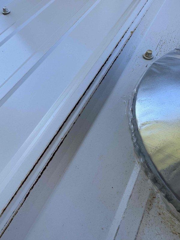 Inspected HVAC installation and identified issues with flue pipe installation. Documented inadequate outside penetration clearance from wall, need for replacement with double wall flue pipe, and improper slope. Noted visible discoloration around flue pipe penetration that requires remediation. Will return to complete necessary corrections to ensure proper venting and code compliance.