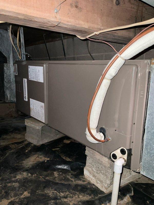 Completed on-site estimate for furnace replacement in residential crawlspace. Existing Champion unit is elevated on concrete blocks with PVC drainage piping and appears to be nearing end of service life. Photographed current installation including connections, refrigerant lines, and mounting configuration to ensure proper sizing and compatibility for replacement quote. Evaluated existing ductwork and electrical connections for inclusion in comprehensive system replacement proposal.