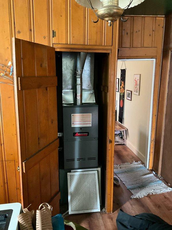 Conducted assessment of existing HVAC system housed in wooden cabinet enclosure, confirming refrigerant depletion as reported. Evaluated current furnace unit with connected ductwork and provided customer with replacement options for complete system upgrade. Customer has requested expedited replacement timeline and has been informed of next steps in the installation process.