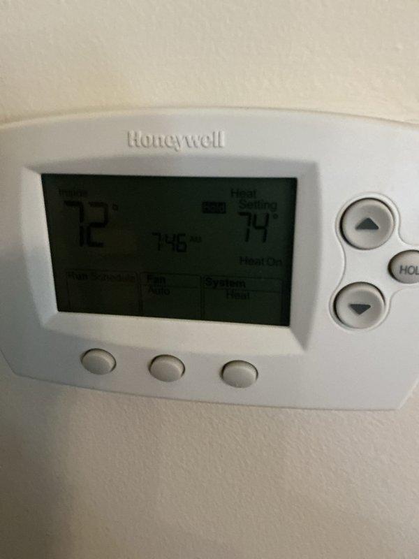 Performed monthly basic maintenance on CCHP-Heating system. Inspected Honeywell thermostat confirming proper operation with heat set to 74° and actual temperature reading 72° with "Heat On" status active. Visually examined furnace unit including gas line connections, condensate drain, and safety components - all functioning correctly.