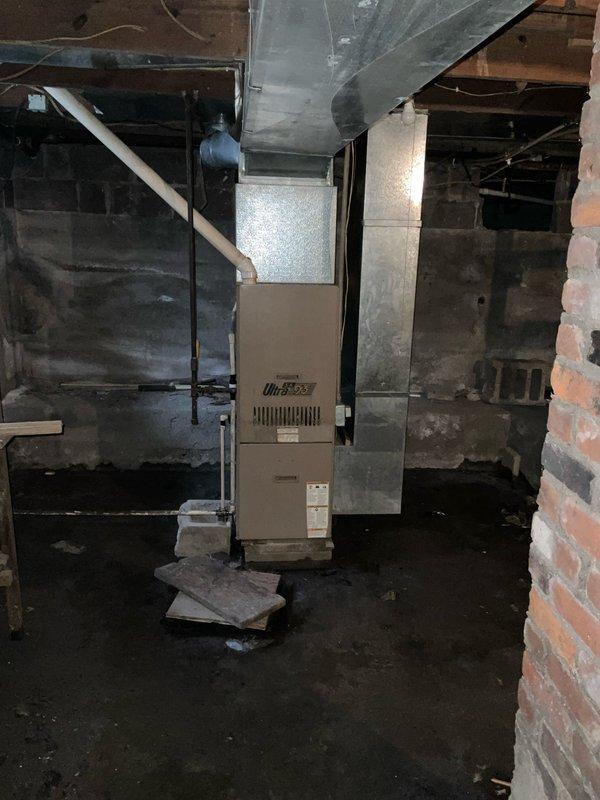 Conducted assessment of 27-year-old furnace in rental property requiring major repairs; recommended full replacement as the most cost-effective solution. Documented existing electrical panel with outdated fabric-covered wiring and inspected current OilStar furnace installation with metal ductwork in unfinished basement. Replacement recommended due to age of unit, deteriorating condition, and long-term economic benefits versus repair costs.