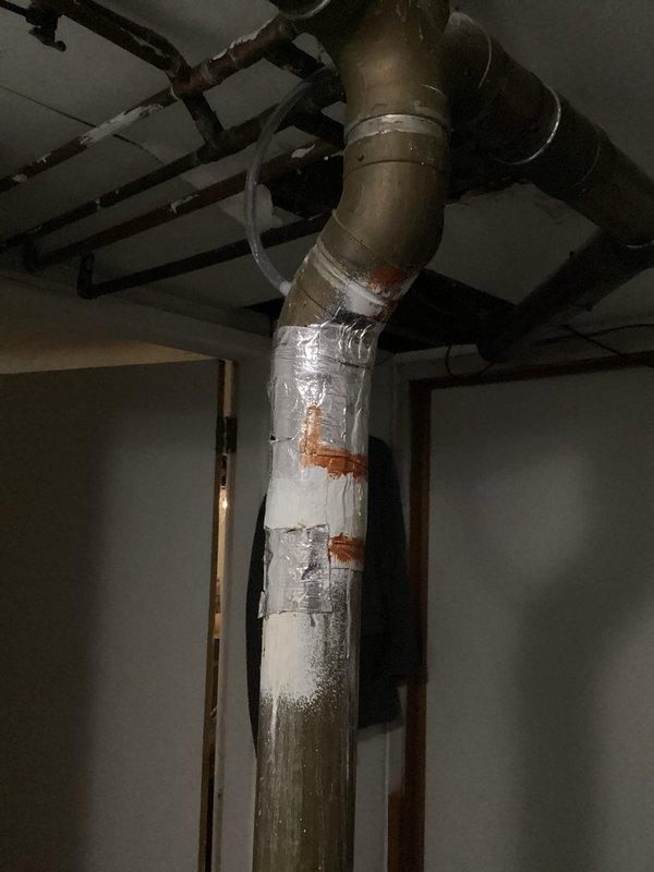 Responded to service call for non-functioning 40-gallon tank water heater that would not relight. Inspection revealed significant corrosion at copper pipe joints and connections, particularly where the pipe bends, with advanced green patina development indicating prolonged moisture exposure. Multiple pipe sections showed evidence of previous repairs with tape/insulation, and replacement was recommended due to deteriorated condition.