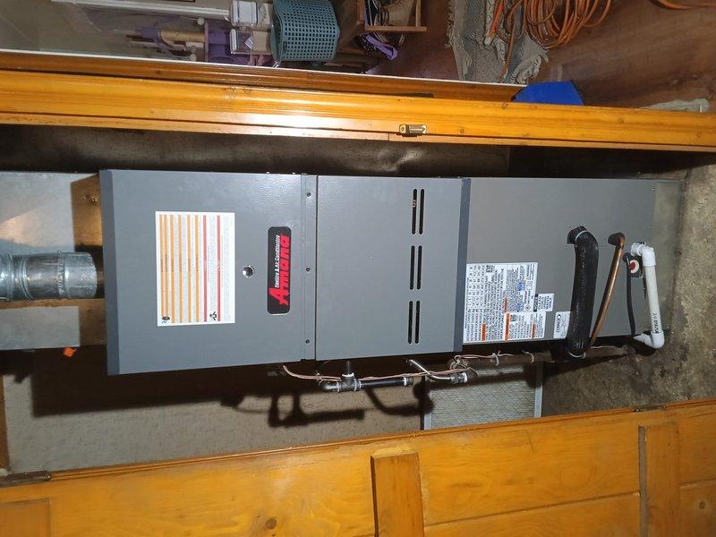 Completed installation of Lennox AC system with matching coil in customer's home. Installed the HVAC unit in basement utility area with proper PVC drainage and ductwork connections. Verified system operation and secured customer approval with appropriate documentation, with Reliable Comfort yard sign placed upon completion.