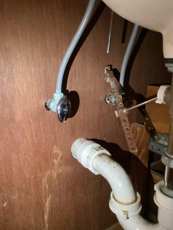 Replaced deteriorated bathroom faucet shutoff valve showing significant oxidation and mineral buildup. Installed new chrome shutoff valve with flexible water line connection, ensuring proper seal and functionality. Inspected surrounding plumbing infrastructure for additional water damage and verified system operation with no leaks upon completion.