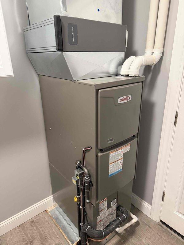 Successfully installed a complete Lennox HVAC system consisting of a new gas furnace and AC unit for residential application. System includes proper venting with PVC exhaust pipes, secure gas line connections, and condensate drain line installation. Mounted and programmed a new Honeywell digital thermostat to control the system, confirming proper functionality of all components before completion.