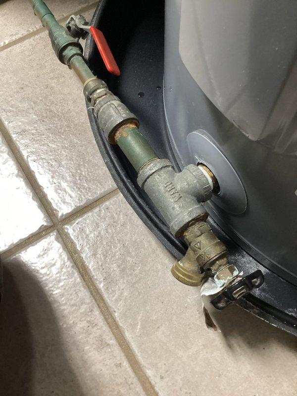 Conducted diagnostic inspection of water heater exhibiting active leak at copper supply line connection. Identified corrosion at threaded joint where supply line enters tank base. Recommended replacement of aging unit due to tank deterioration and potential for catastrophic failure.