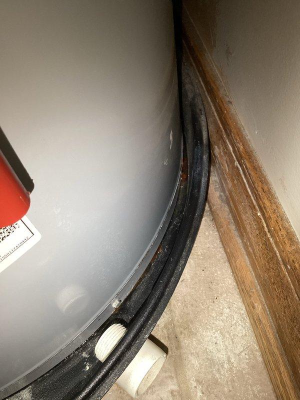 Conducted diagnostic inspection of water heater exhibiting active leak at copper supply line connection. Identified corrosion at threaded joint where supply line enters tank base. Recommended replacement of aging unit due to tank deterioration and potential for catastrophic failure.