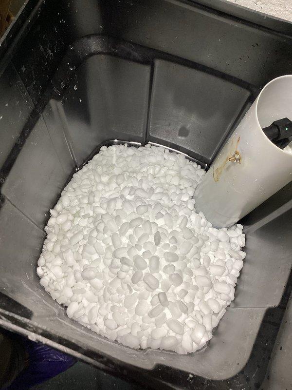 Conducted monthly plumbing inspection of the property, examining the water softener system and salt pellet levels in the brine tank. Inspected the A.O. Smith 100-gallon water heater, checking all connections, flexible conduits, and copper pipe fittings for proper function and potential leaks throughout the basement utility area.