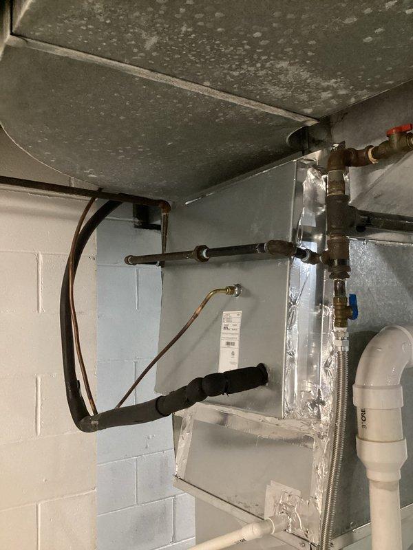 Responded to a complimentary warranty service call regarding furnace knocking noise. Inspected system and identified loose component causing the noise. Secured component and verified proper operation. Thermostat functioning normally at 70° with heat and fan auto settings. Noted some ceiling water damage/mold in utility area that may require future attention.