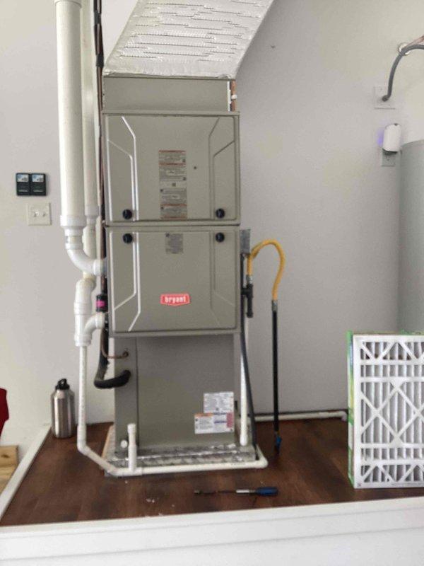 Performed complimentary tune-up on Bryant heating system. Inspected unit thoroughly for leaks as previous contractors had reported and repaired an installation-related leak issue. Verified system operation, checked all connections, and confirmed the repair integrity with no active leaks detected. Left replacement air filter alongside unit for future use.