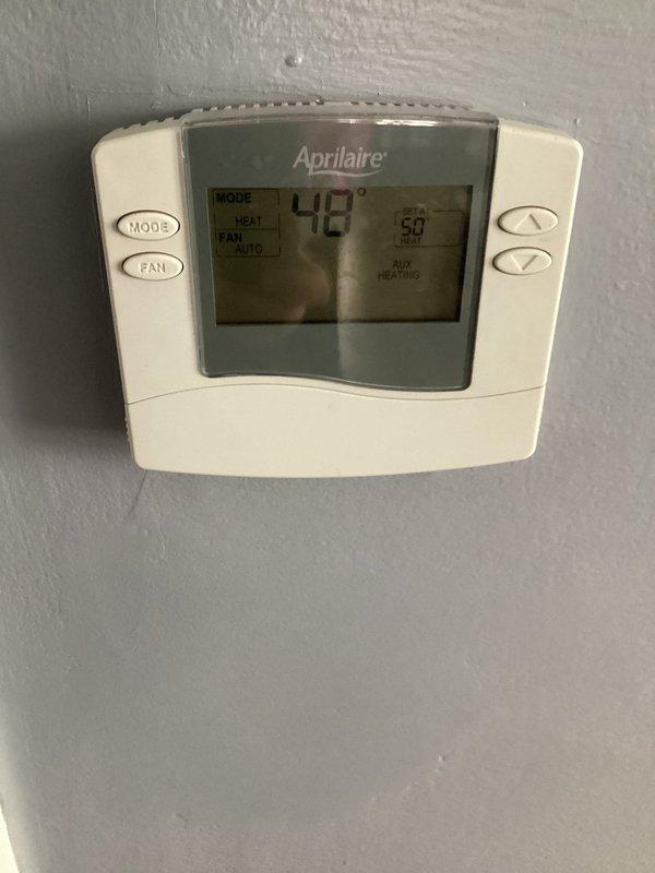 Responded to after-hours emergency call for no heat with unit making buzzing noise. Diagnosed system with 48°F indoor temperature and AUX HEAT indicator active despite Guardian furnace not producing heat. Resolved electrical issue at condensing unit causing contactor to buzz without engaging, restored proper operation with heat output returning to setpoint of 58°F.