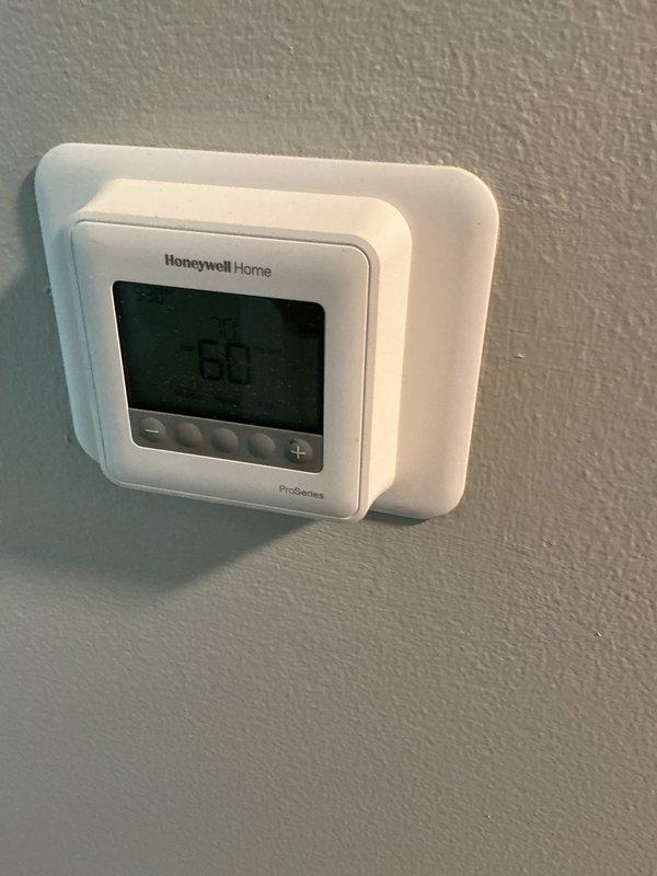 Performed routine maintenance inspection on A.O. Smith natural gas water heater (manufactured 07/2021) and Honeywell Home ProSeries thermostat. Verified proper operation of both systems, with thermostat currently set to 60°F. Completed standard clean and check service with photo documentation of equipment for service records.