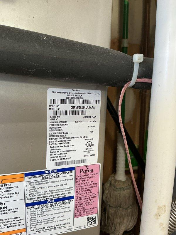 Performed monthly basic heating maintenance service on Carrier system. Inspected thermostat operation, confirming proper functionality with display showing 71°F and system reminders for humidifier pad and filter checks. Examined equipment labels and verified R-410A Puron refrigerant system specifications.
