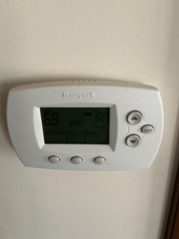 Performed monthly basic heating maintenance service on CCHP system. Inspected Honeywell thermostat displaying 59°F and verified proper operation. Examined outdoor condensing unit, checked for debris accumulation around unit, and confirmed system is functioning within normal parameters.