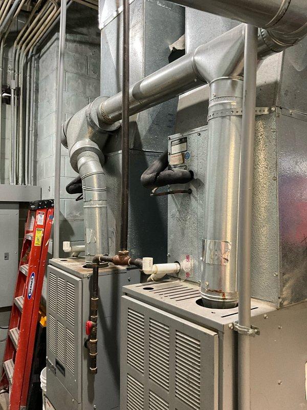 Conducted heat maintenance inspection on dual furnace system revealing severe safety hazards including rusted/corroded heat exchangers, scorched circuit board, and damaged wiring harness bridle in both units. Documented condition of existing HVAC equipment and ductwork system via photographs. Recommended complete replacement of both furnaces due to critical safety concerns and provided full system estimate for new installation.