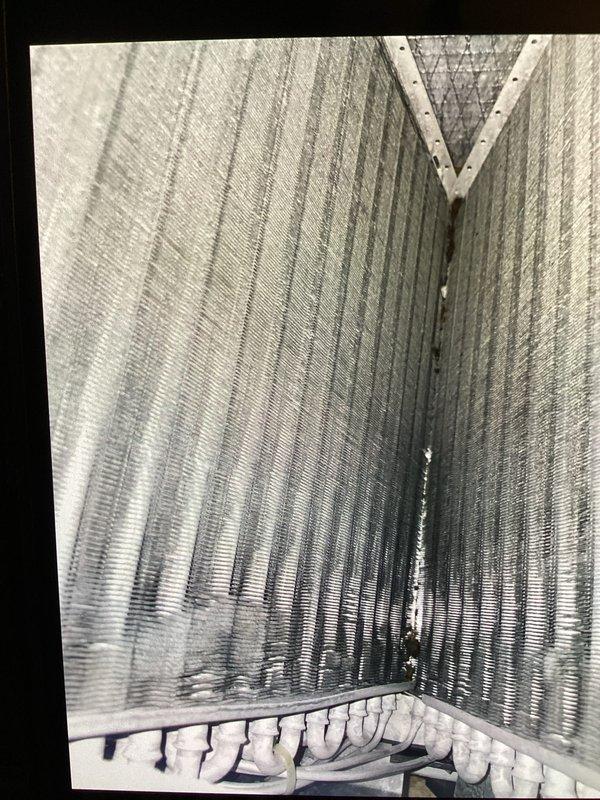 Performed basic monthly maintenance on a CCH system. Inspected heat exchanger and cooling coils, documenting condition with photos. Noted existing 20x25x4 filter (not included in service).