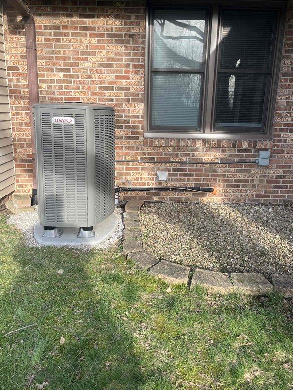Successfully installed a complete Lennox Heat Pump System including outdoor condenser unit (positioned on concrete pad adjacent to brick exterior) and indoor air handler/furnace with associated ductwork in utility area. System was properly connected to existing ductwork, with all electrical connections secured and system tested for proper operation following installation.