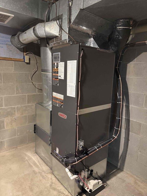 Successfully installed a complete Lennox Heat Pump System including outdoor condenser unit (positioned on concrete pad adjacent to brick exterior) and indoor air handler/furnace with associated ductwork in utility area. System was properly connected to existing ductwork, with all electrical connections secured and system tested for proper operation following installation.