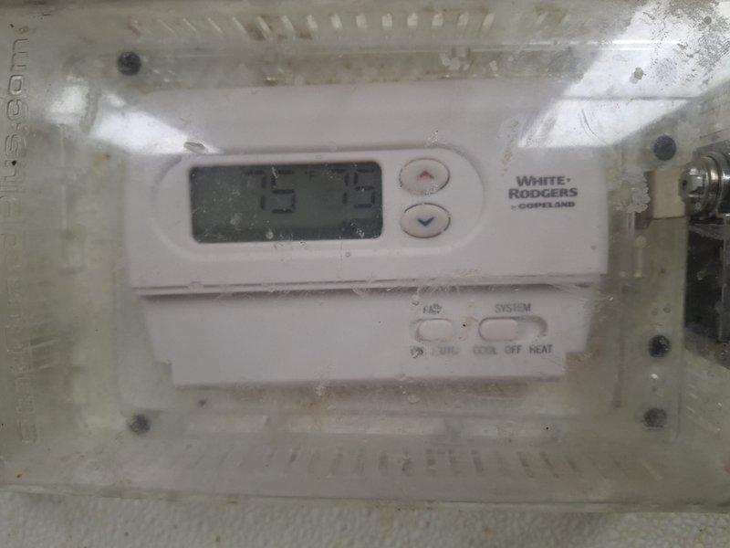 Performed warranty inspection on Daikin rooftop commercial HVAC system. Examined and verified proper operation of White-Rodgers digital thermostat (setpoint 75°F). Documentation photos taken of both thermostat installation and rooftop unit for warranty verification purposes.