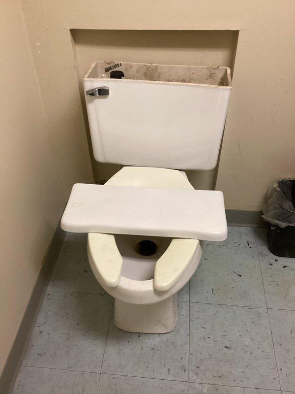 # Plumbing Estimate - Complete System Replacement

Responded to service call regarding comprehensive plumbing system evaluation for potential full replacement. Customer reported uncertainty about current system functionality and condition of existing fixtures. Performed thorough assessment of accessible plumbing infrastructure throughout property.

Inspected bathroom fixtures including wall-mounted tank toilet with exposed internal mechanisms. Tank lid was removed during evaluation to assess flush valve, fill valve, and flapper condition. Noted split-seat configuration and overall fixture age consistent with older installation. Examined floor-mounted toilet bowl connection and checked for signs of leaking, deterioration, or structural concerns around base mounting area.

Conducted detailed inspection of exposed PVC drainage and supply piping system in utility area. Documented extensive network of white PVC pipes with multiple 90-degree elbows, horizontal and vertical runs, and various 