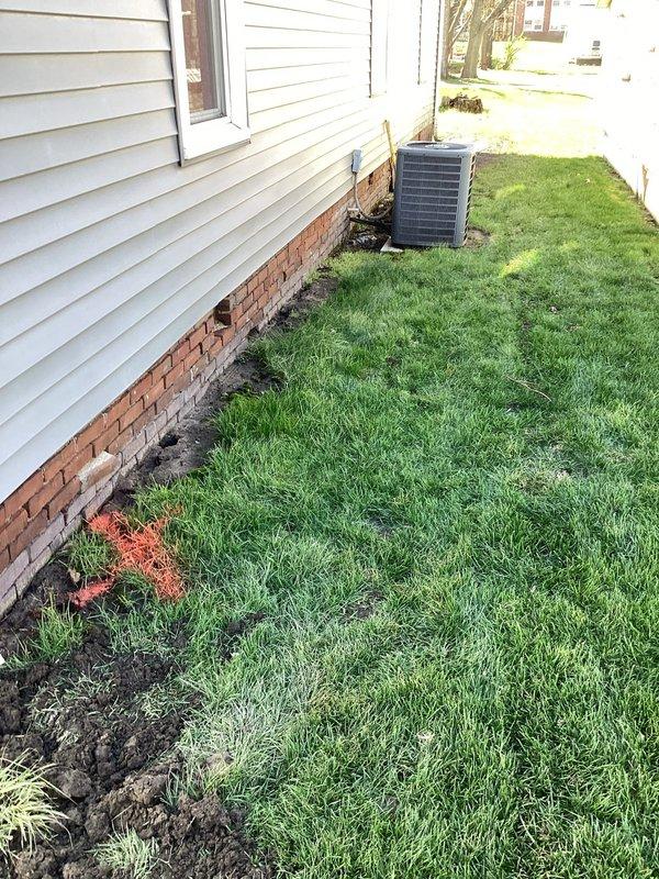 Responded to service call for sewer backup into residence. Upon arrival, located and inspected exterior sewer cleanout access points at foundation level. Documented condition of cleanout pipes and surrounding drainage area, noting soil disturbance and staining patterns consistent with wastewater backup. Marked utility locations on lawn and assessed exterior plumbing access points for main line intervention.