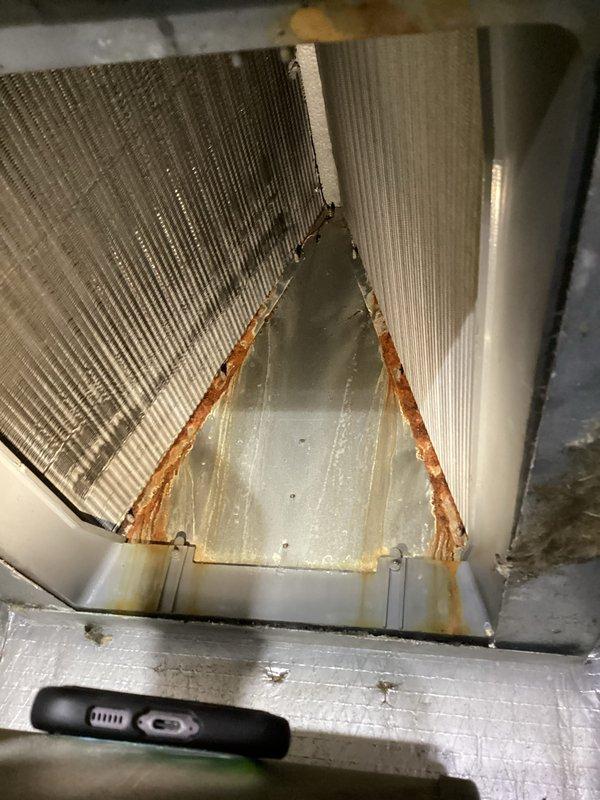 # Service Report

Performed heating maintenance on combined cooling and heating package unit. Upon inspection, discovered significant structural damage to the evaporator coil assembly with a large triangular section separated from the main unit, exhibiting extensive rust-colored corrosion along the damaged edges. This coil deterioration explains the customer's reported concerns about high electric bills and inefficient cooling operation, as the compromised coil integrity severely impacts system performance and efficiency. Documented equipment nameplate specifications and photographed the damaged coil assembly showing the displaced fin section and corrosion for warranty and replacement evaluation. Unit requires evaporator coil replacement to restore proper cooling function and system efficiency. Replaced standard 16x20x1 air filter as part of basic monthly maintenance service.