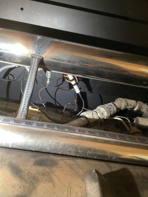 # Service Report: Gas Fireplace Ignitor Switch Replacement

Responded to service call for non-functioning gas fireplace ignition system. Upon inspection, diagnosed faulty ignitor switch preventing pilot light ignition. Accessed internal components through top access panel and removed defective ignitor switch assembly. Verified gas supply line integrity and electrical connections during component removal. Installed replacement ignitor switch, ensuring proper wire routing and secure mounting to burner assembly. Tested ignition sequence multiple times to confirm reliable spark generation and pilot light ignition. Verified all safety interlocks and flame sensing operations functioned correctly. Reinstalled access panel and confirmed unit returned to normal operating condition with consistent ignition performance.