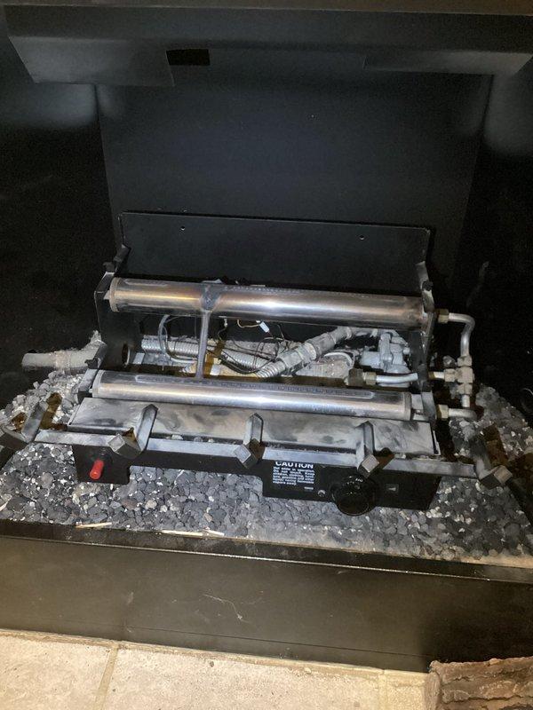 # Service Report: Gas Fireplace Ignitor Switch Replacement

Responded to service call for non-functioning gas fireplace ignition system. Upon inspection, diagnosed faulty ignitor switch preventing pilot light ignition. Accessed internal components through top access panel and removed defective ignitor switch assembly. Verified gas supply line integrity and electrical connections during component removal. Installed replacement ignitor switch, ensuring proper wire routing and secure mounting to burner assembly. Tested ignition sequence multiple times to confirm reliable spark generation and pilot light ignition. Verified all safety interlocks and flame sensing operations functioned correctly. Reinstalled access panel and confirmed unit returned to normal operating condition with consistent ignition performance.